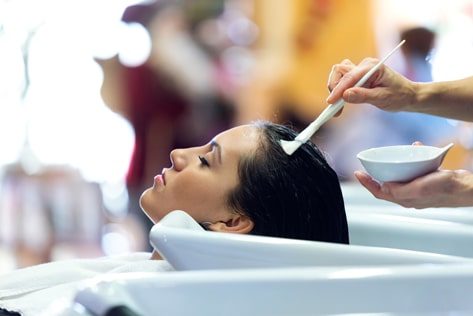 Hairdresser Applying Hair Treatment — Hair Salon in Darwin, NT