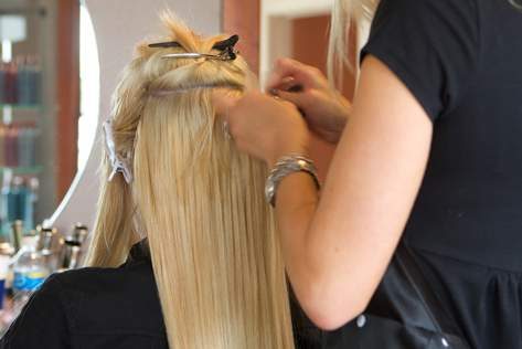 Hairdresser Applying Hair Extensions — Hair Salon in Darwin, NT