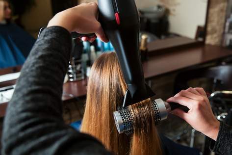 Hairstylist Using Hair Dryer — Hair Salon in Darwin, NT