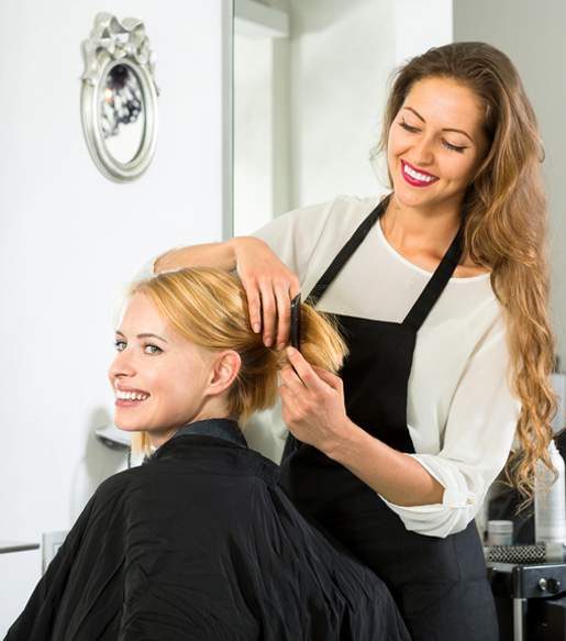 Hairstylist Combing Customer's Hair — Hair Salon in Darwin, NT