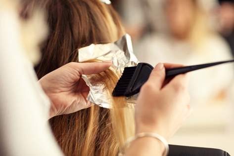 Hairdresser Applying Colour To Hair — Hair Salon in Darwin, NT