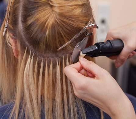 Hairdresser Doing Hair Extensions — Hair Salon in Darwin, NT